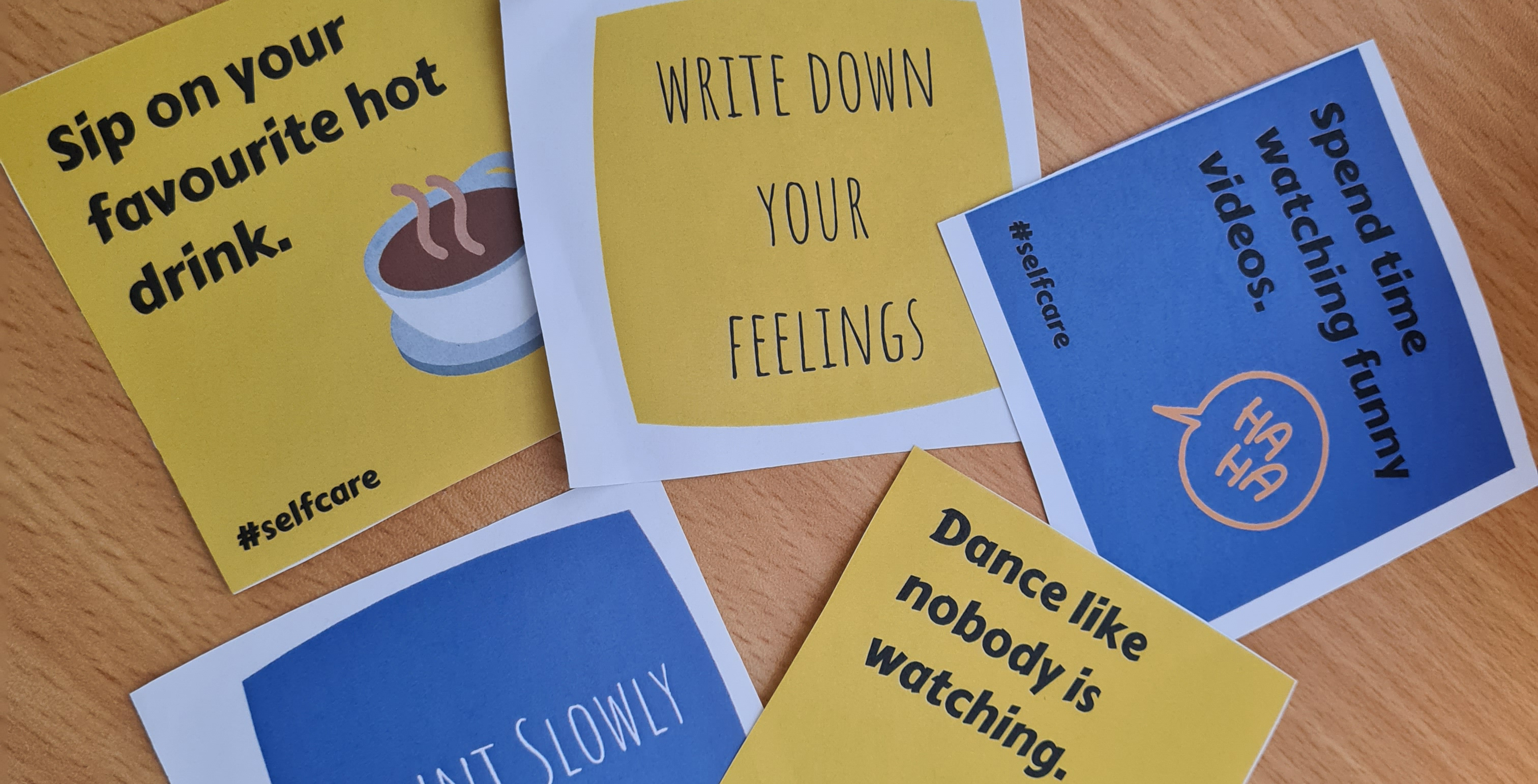 papers containing self care messages on a table