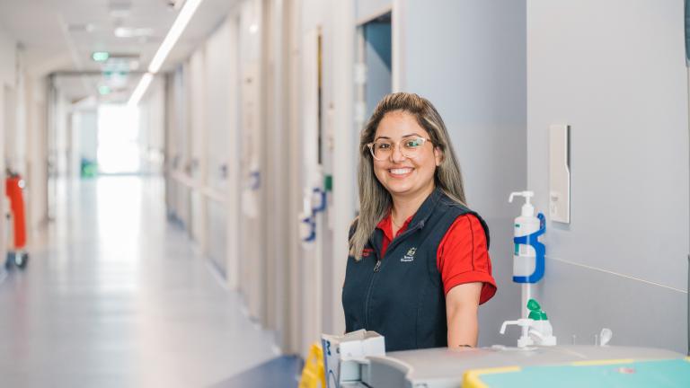 A hospital worker smiling in the hallways of Royal Hobart Hospital.