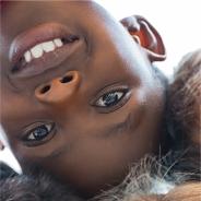 Image of an upside down young boy smiling 