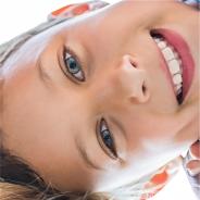 Image of an upside down young girl smiling